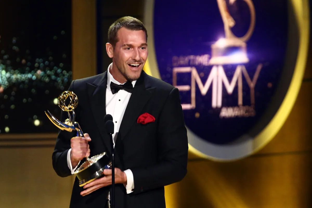 Brandon McMillan holding his Daytime Emmy Award
